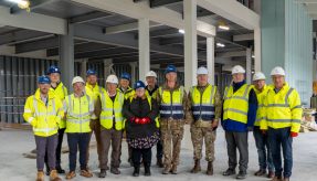 Representatives of Army Infrastructure and the Armoured Cavalry programme (centre), the DIO (right) and Aspire Defence (left), inside the Ajax facility under construction at Warminster Garrison. Copyright: Aspire Media Services.