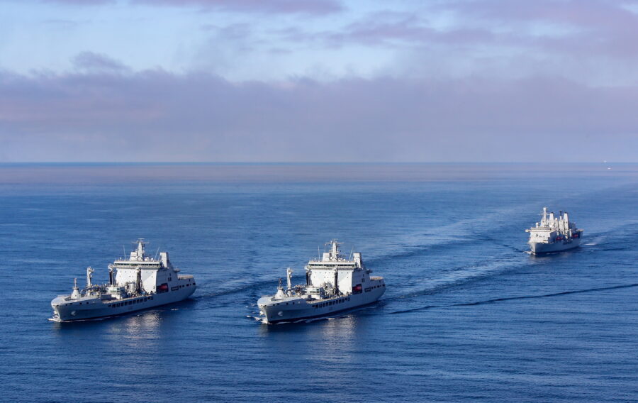 A Royal Navy Merlin Mk2, from 814 NAS, conducted a photographic exercise (PHOTEX) involving RFA Tideforce (A139) (left) and RFA Tidesurge (A138) (right), with RFA Fort Victoria (A387) (rear) off the Southwest Coast.