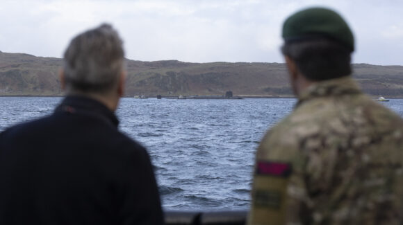 18 Apr 2026 - Prime Minister Keir Starmer and First Sea Lord, General Sir Gwyn Jenkins KCB OBE ADC looking at a Vanguard Class Submarine. The Prime Minister and Defence Secretary have welcomed Royal Navy submariners home following the completion of the UK's latest nuclear deterrent patrol. Prime Minister Keir Starmer and Defence Secretary John Healey MP joined the First Sea Lord, and Chief of Defence Nuclear on the Clyde to welcome home the Vanguard-class submarine as it returned from patrol. The submarine was deployed on Operation Relentless, the UK's Continuous At Sea Deterrent (CASD), which has ensured at least one nuclear-armed ballistic missile submarine has been on patrol, undetected, every minute of every day since April 1969. After meeting submariners onboard, the submarine, the Prime Minister and Defence Secretary were hosted by the First Sea Lord at HM Naval Base Clyde where they met personnel from 43 Commando who help protect the base and submarines. The Prime Minister, Defence Secretary and First Sea Lord also spent time with submariners and their families gathered at the base for a welcome home event organised by Naval Base staff and the Naval Service Family and People Support (NSFPS) team.