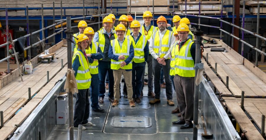 ZeroUSV welcomed recently representatives from the Royal Navy, MOD and NSO (National Shipbuilding Office) to Manor Marine’s headquarters in Portland for a VIP tour showcasing the company’s expanding autonomous maritime capabilities. The visit follows ZeroUSV’s recent strategic investment in Manor Marine, strengthening the partnership and boosting sovereign UK production capacity for the company’s Oceanus class uncrewed surface vessels (USVs). During the tour, guests were shown around Manor Marine’s facilities and given an update on the ongoing build of ZeroUSV’s next-generation Oceanus17 platform, which remains on track to be launched in July this year. The tour demonstrated ZeroUSV’s ability to rapidly scale production of advanced British-built autonomous vessels, while highlighting the strength of UK sovereign shipbuilding and innovation within the maritime defence sector. Designed for long-range, over-the-horizon operations, Oceanus17 represents a significant step forward in modular, multi-role autonomous maritime capability. The 17-metre platform features a 4-tonne payload capacity and a 20ft ISO-compatible mission deck, enabling rapid reconfiguration for a wide range of defence, security and commercial maritime missions. Matthew Ratsey, Managing Director of ZeroUSV, said: “It was a pleasure to welcome representatives from the Royal Navy and MOD, and showcase the progress being made across our Oceanus programme. “The visit highlighted not only the pace at which we are developing advanced autonomous capabilities, but also the strength of British engineering and sovereign shipbuilding. Through our partnership with Manor Marine, we are building the foundations needed to deliver scalable, mission-ready USV capability for both defence and commercial applications.” Picture caption: Matthew Ratsey with the VIP tour aboard the Oceanus17 vessel 