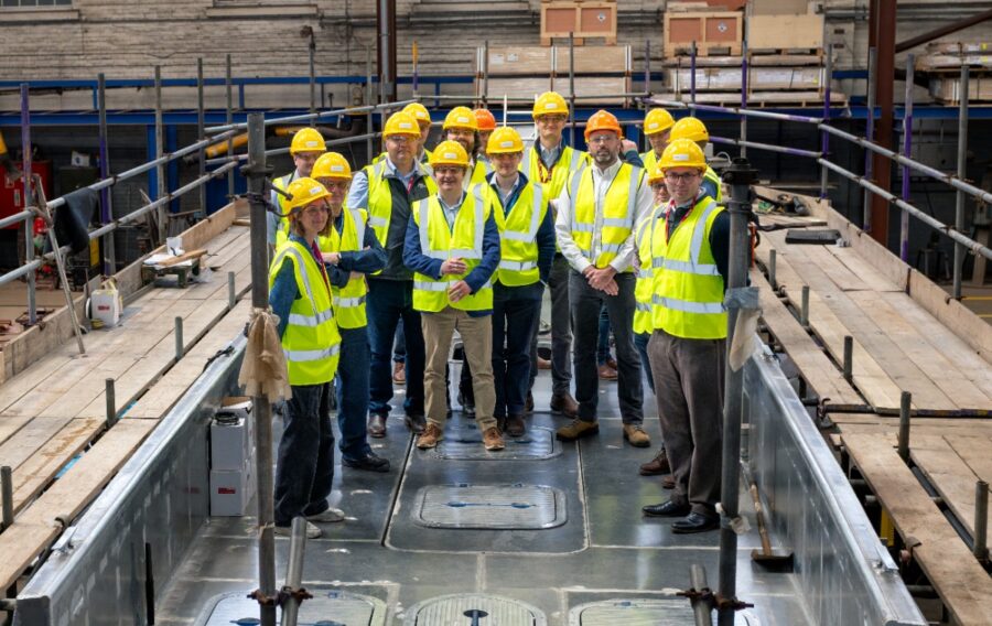 ZeroUSV welcomed recently representatives from the Royal Navy, MOD and NSO (National Shipbuilding Office) to Manor Marine’s headquarters in Portland for a VIP tour showcasing the company’s expanding autonomous maritime capabilities. The visit follows ZeroUSV’s recent strategic investment in Manor Marine, strengthening the partnership and boosting sovereign UK production capacity for the company’s Oceanus class uncrewed surface vessels (USVs). During the tour, guests were shown around Manor Marine’s facilities and given an update on the ongoing build of ZeroUSV’s next-generation Oceanus17 platform, which remains on track to be launched in July this year. The tour demonstrated ZeroUSV’s ability to rapidly scale production of advanced British-built autonomous vessels, while highlighting the strength of UK sovereign shipbuilding and innovation within the maritime defence sector. Designed for long-range, over-the-horizon operations, Oceanus17 represents a significant step forward in modular, multi-role autonomous maritime capability. The 17-metre platform features a 4-tonne payload capacity and a 20ft ISO-compatible mission deck, enabling rapid reconfiguration for a wide range of defence, security and commercial maritime missions. Matthew Ratsey, Managing Director of ZeroUSV, said: “It was a pleasure to welcome representatives from the Royal Navy and MOD, and showcase the progress being made across our Oceanus programme. “The visit highlighted not only the pace at which we are developing advanced autonomous capabilities, but also the strength of British engineering and sovereign shipbuilding. Through our partnership with Manor Marine, we are building the foundations needed to deliver scalable, mission-ready USV capability for both defence and commercial applications.” Picture caption: Matthew Ratsey with the VIP tour aboard the Oceanus17 vessel 